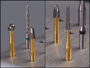 four carbide dental burs and a diamond dental bur