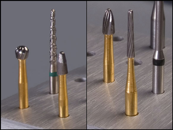 four carbide burs and a diamond bur (used in dentistry)